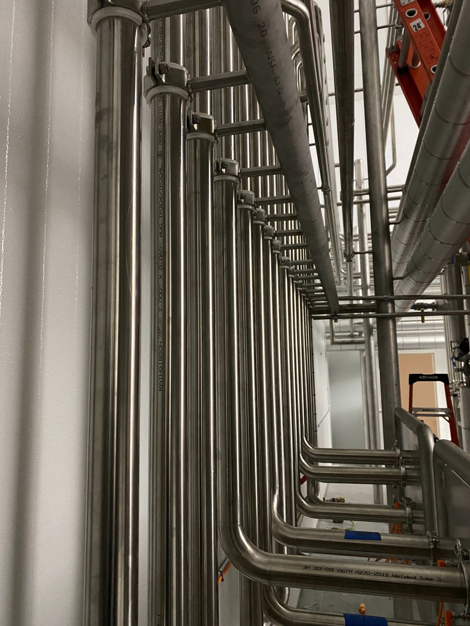 Ordered vertical runs of stainless sanitary piping